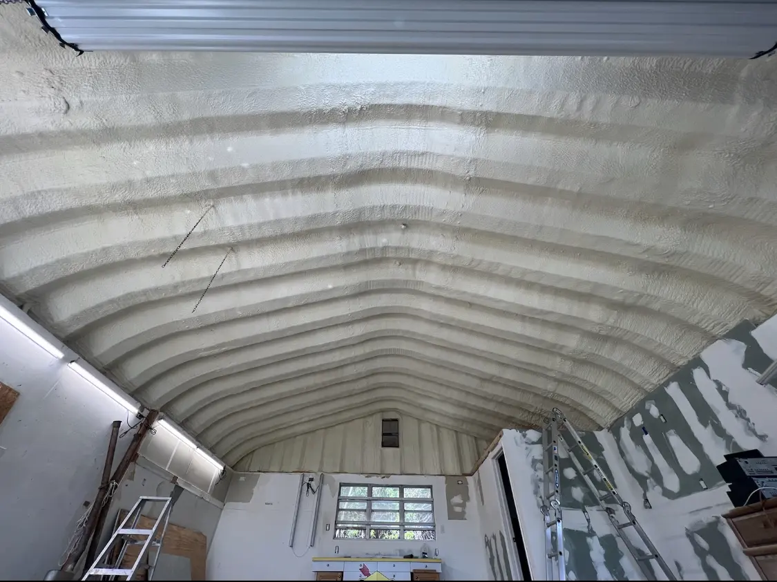 Spray polyurethane foam applied to the underside of a metal roof deck in Spencer